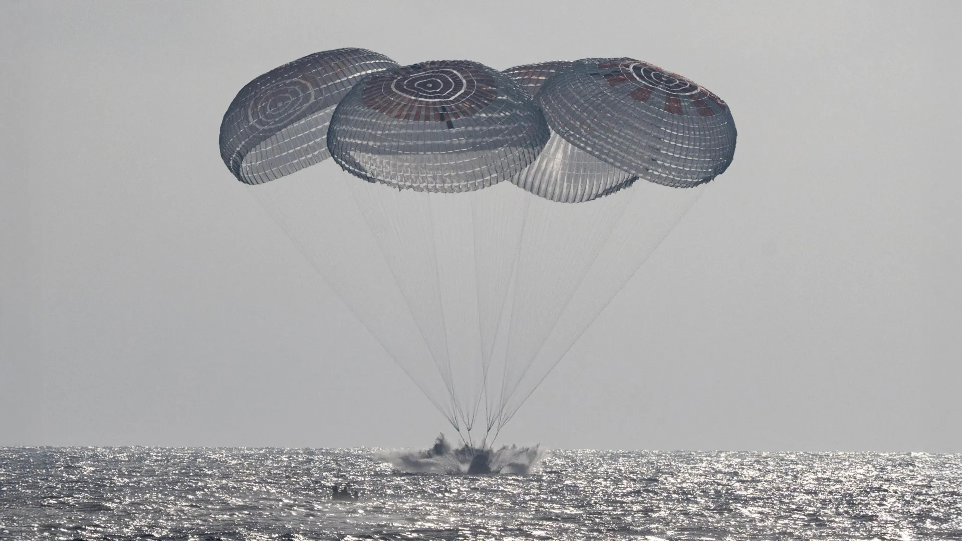 NASA astronauts splash down after 100 million miles in space